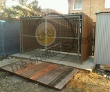 Bespoke wood cladded cycle shelter with box profile roof and mesh gates