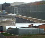 Taurus high security compound cycle shelter for 128 cycles with perforated steel sheet sidewalls, BREEAM 2008 specification, installed at Winsford Academy 
