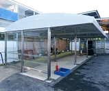 Bespoke canopy for Automatic Ticketing Gate at Tottenham Hale Station, featuring Stainless Steel legs, integrated rainwater goods, and toughened glass side screens 